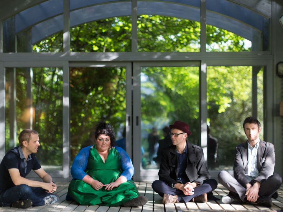 The Breath (c) York Tillyer - 4 members, sat onteh floor in front of a large arched window