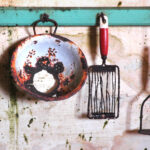 Rusted utensils on wall hooks
