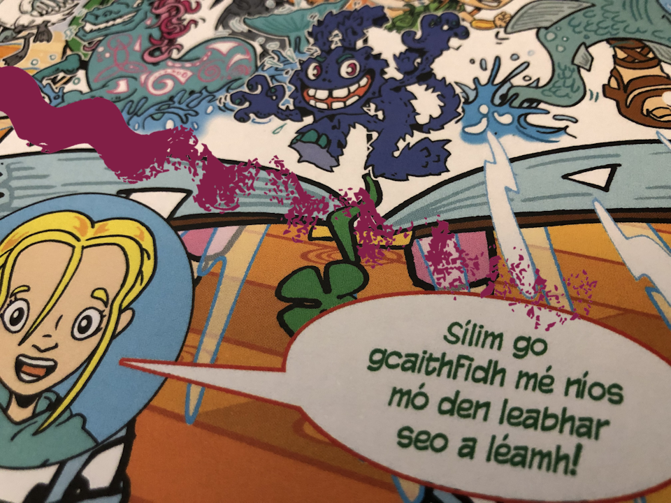 Close up detail of a bi-lingual comic speech bubble stating "I think I need to read more of this book!" in Gaeilge, featuresd in a book called Brave Maeve, drawn and written by Stu Harrison.