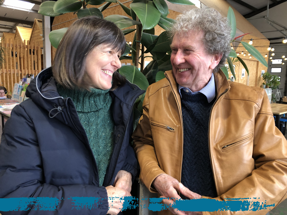 Dr Ann Hoskins (left) and John Chandler laught together, Feb 2024.